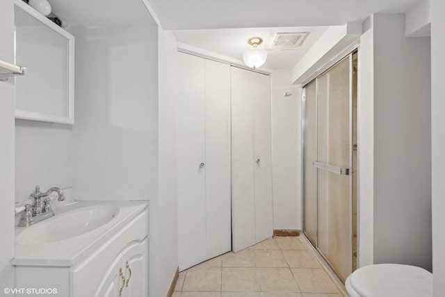 bathroom with vanity, toilet, and tile patterned flooring