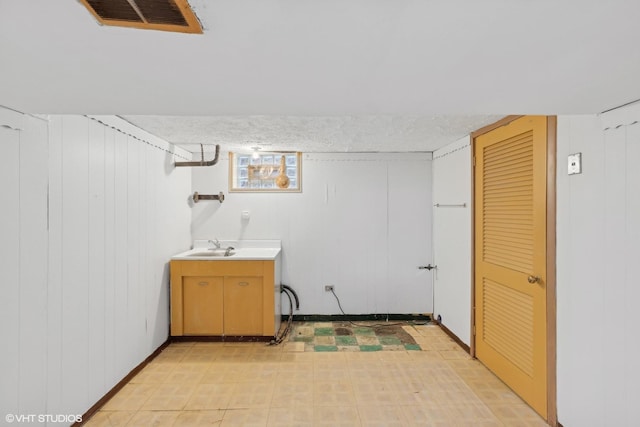 washroom with sink and a textured ceiling