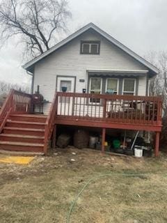 back of house featuring a wooden deck and a yard