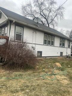 view of side of home with a lawn