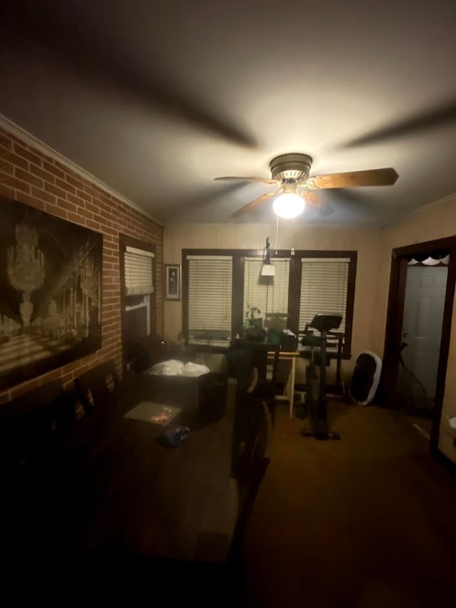 bedroom featuring ornamental molding and brick wall