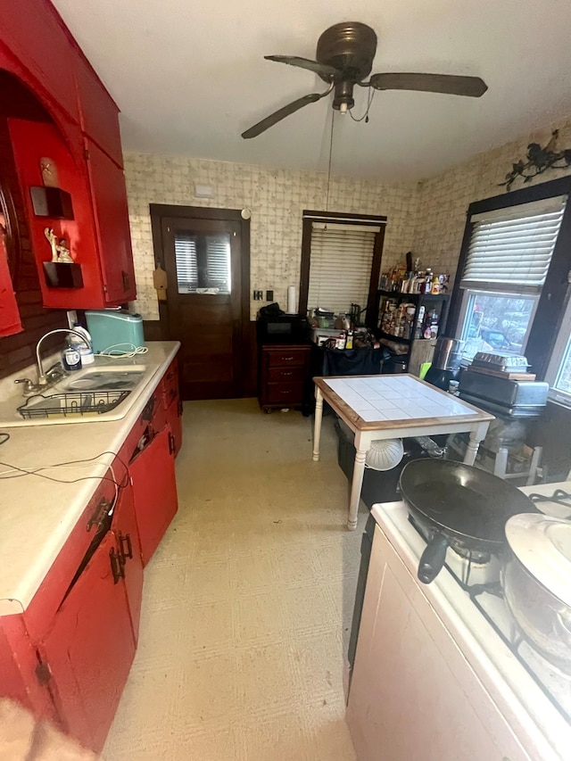 kitchen featuring sink, tile countertops, and ceiling fan