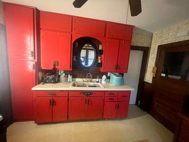 kitchen with lofted ceiling, sink, and ceiling fan