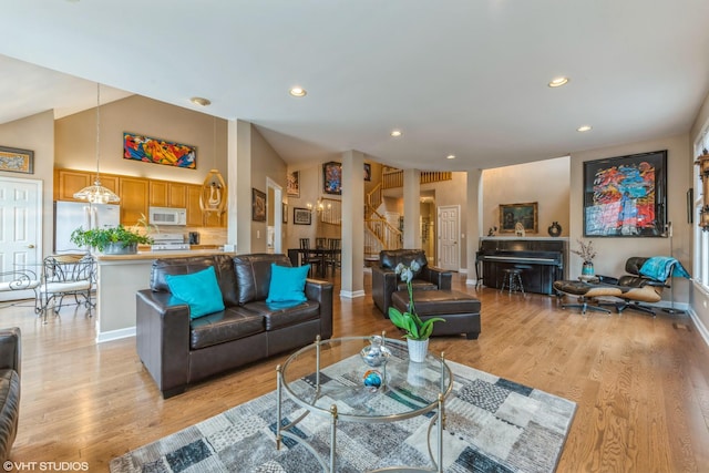 living room with lofted ceiling and light wood-type flooring