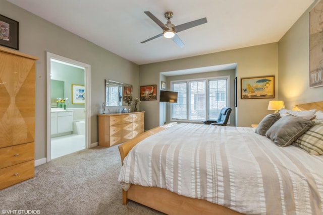 bedroom with ceiling fan, connected bathroom, and carpet flooring