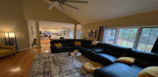 living room featuring ceiling fan, high vaulted ceiling, light hardwood / wood-style floors, and ornate columns