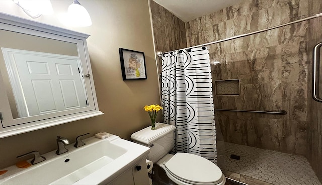 bathroom featuring vanity, toilet, and walk in shower