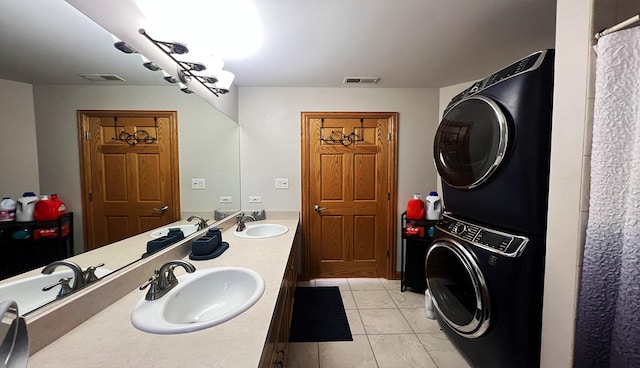 bathroom with vanity, stacked washing maching and dryer, and tile patterned flooring