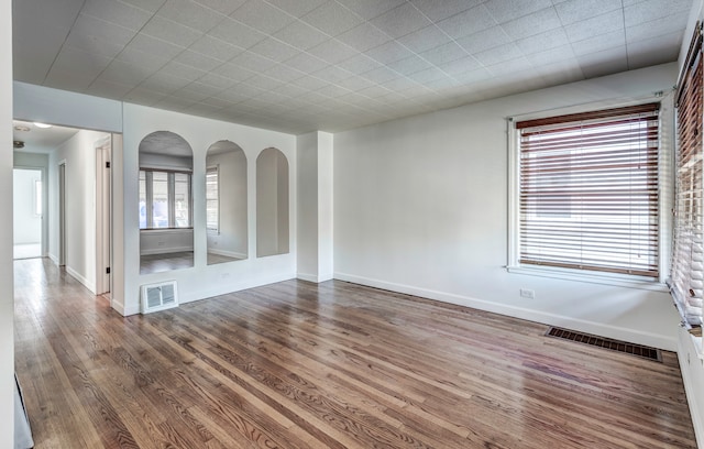 unfurnished room with hardwood / wood-style flooring