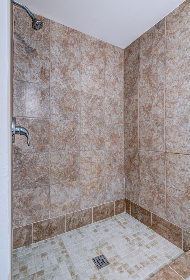 bathroom with tiled shower