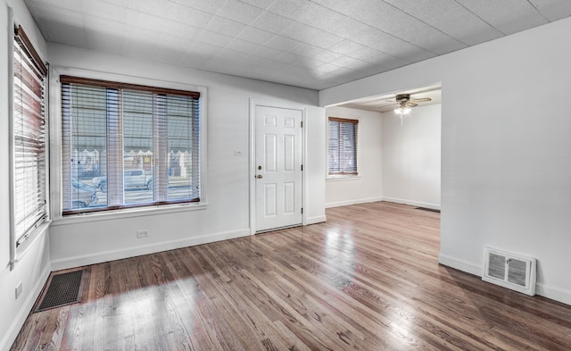 empty room featuring wood-type flooring and ceiling fan