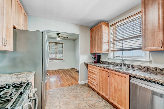 kitchen with ceiling fan, appliances with stainless steel finishes, a wealth of natural light, and light tile patterned floors