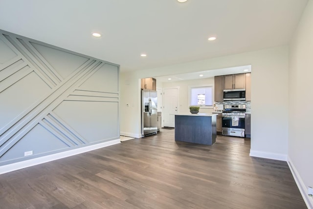 kitchen with tasteful backsplash, stainless steel appliances, dark hardwood / wood-style floors, and a kitchen island