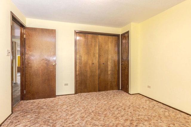 unfurnished bedroom with carpet floors and a closet