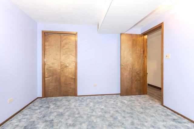 unfurnished bedroom with light carpet and a closet