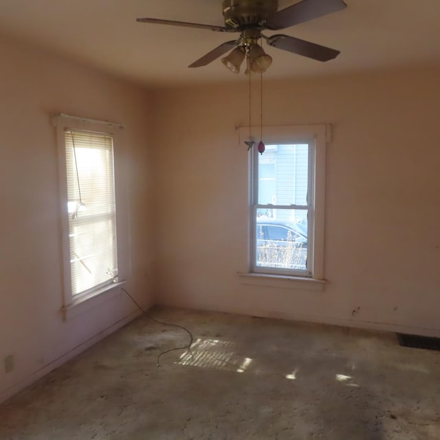 empty room with plenty of natural light and ceiling fan