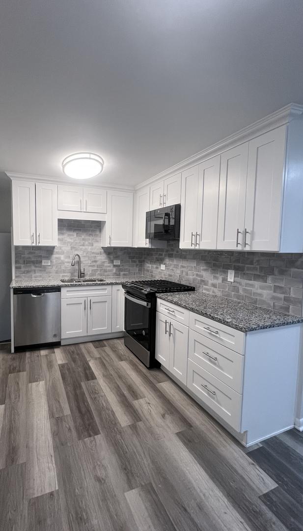 kitchen featuring dark wood-type flooring, sink, gas stove, white cabinetry, and dishwasher