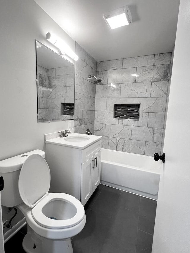 full bathroom with tile patterned flooring, tiled shower / bath, vanity, and toilet