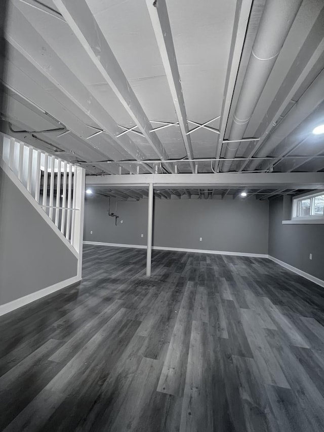 basement featuring dark hardwood / wood-style flooring