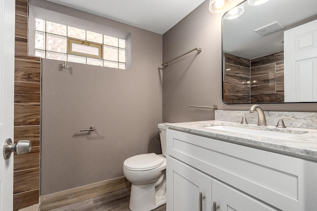 bathroom featuring hardwood / wood-style flooring, vanity, and toilet