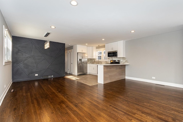 unfurnished living room featuring dark hardwood / wood-style flooring and sink