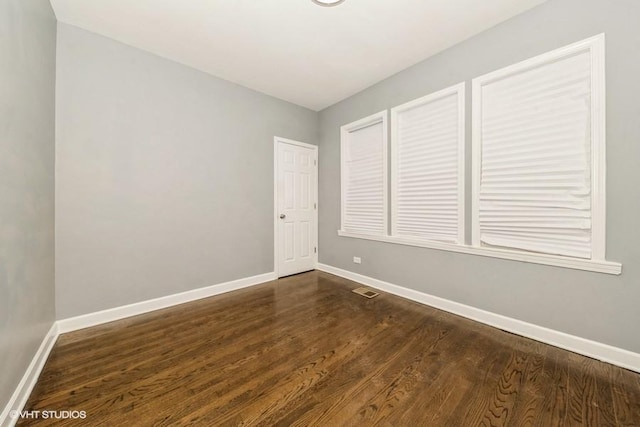 unfurnished room featuring dark hardwood / wood-style flooring