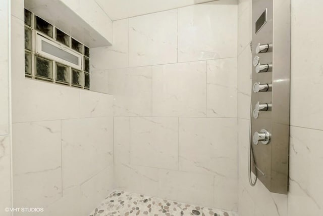 bathroom with a tile shower