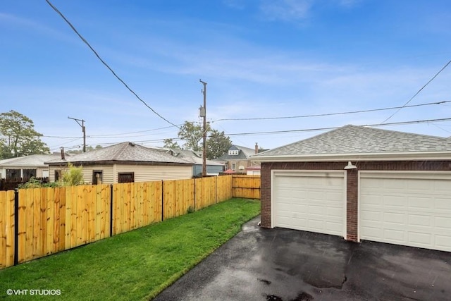 garage featuring a lawn