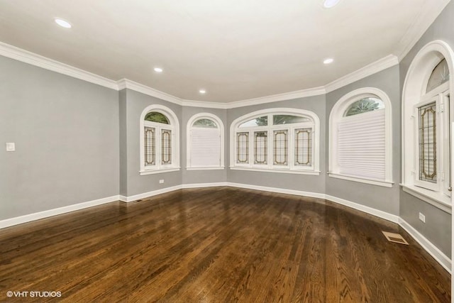 spare room with ornamental molding, dark hardwood / wood-style floors, and a healthy amount of sunlight