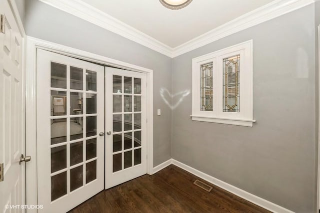 doorway to outside with crown molding, dark hardwood / wood-style flooring, and french doors