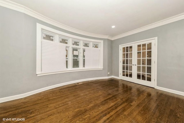 spare room featuring dark hardwood / wood-style floors, ornamental molding, and french doors