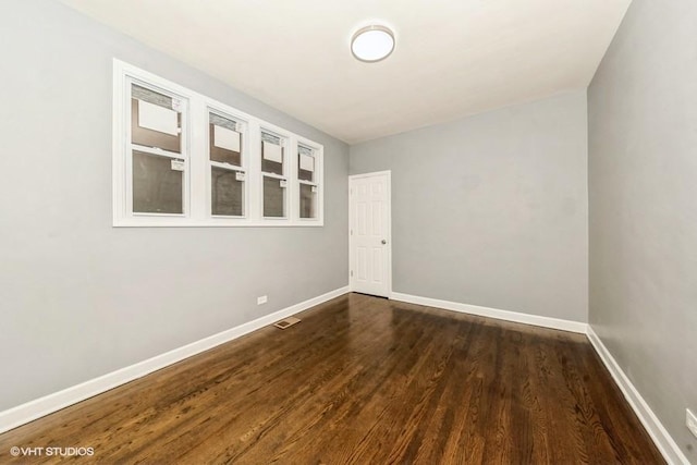 empty room featuring dark wood-type flooring