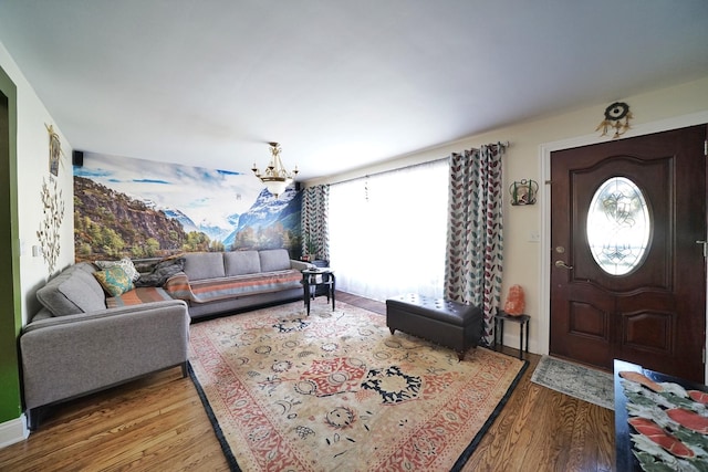 living room featuring wood-type flooring and an inviting chandelier