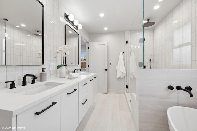 bathroom featuring independent shower and bath, vanity, tasteful backsplash, and tile walls