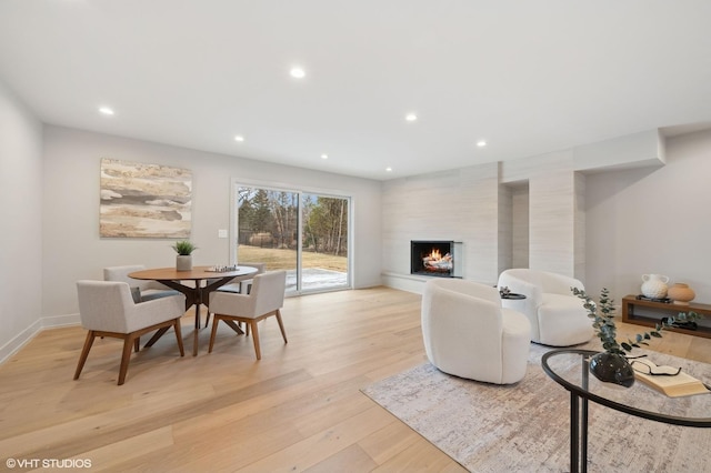 living room with a fireplace and light hardwood / wood-style flooring