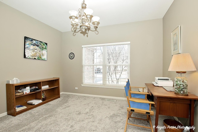 carpeted home office with a notable chandelier