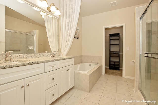 bathroom featuring plus walk in shower, tile patterned floors, an inviting chandelier, and vanity