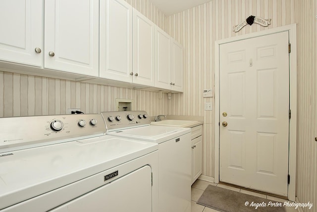 laundry area featuring cabinets, independent washer and dryer, sink, and light tile patterned floors