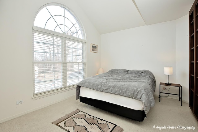 carpeted bedroom with vaulted ceiling