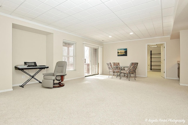 sitting room with crown molding and light colored carpet