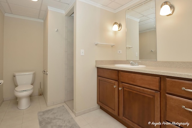 bathroom featuring vanity, tile patterned flooring, ornamental molding, and toilet