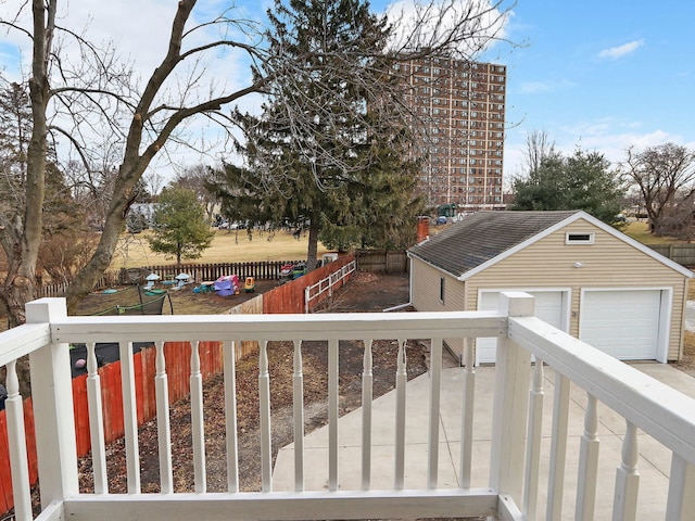 wooden deck with a garage and an outdoor structure