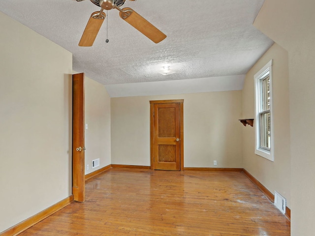 unfurnished room featuring ceiling fan, a textured ceiling, and light hardwood / wood-style floors