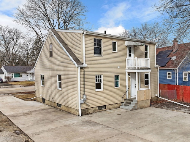 back of house with a balcony