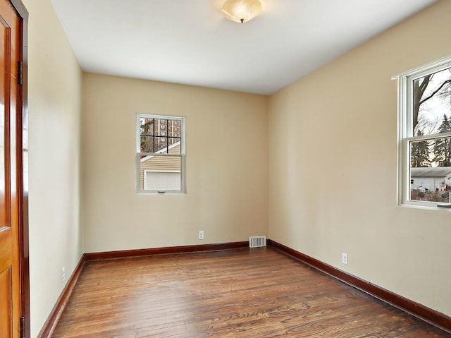 unfurnished room with dark hardwood / wood-style floors