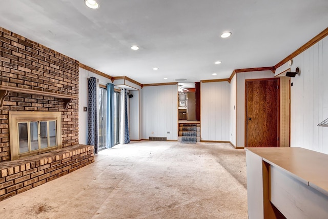 unfurnished living room with baseboards, a fireplace, ornamental molding, and recessed lighting