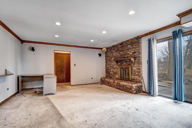 unfurnished living room featuring baseboards, a brick fireplace, light colored carpet, and crown molding