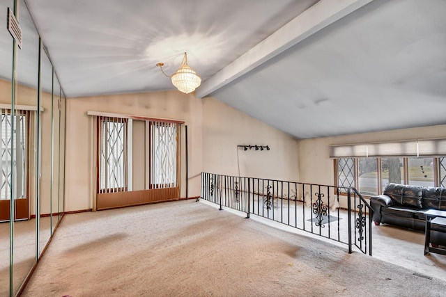 carpeted empty room with a chandelier, lofted ceiling with beams, and baseboards