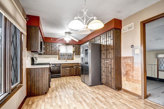 kitchen featuring light wood-style floors, visible vents, stainless steel appliances, and a sink