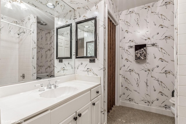 bathroom featuring vanity, tile patterned floors, and toilet